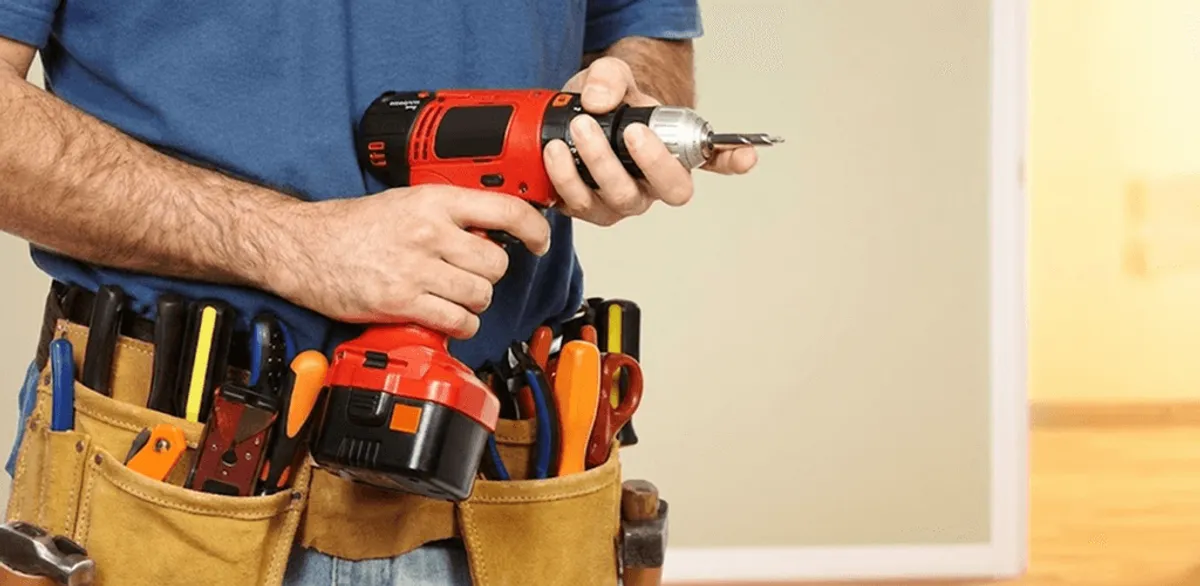 Handyman holding a power drill for home repairs and installations in Minneapolis, MN